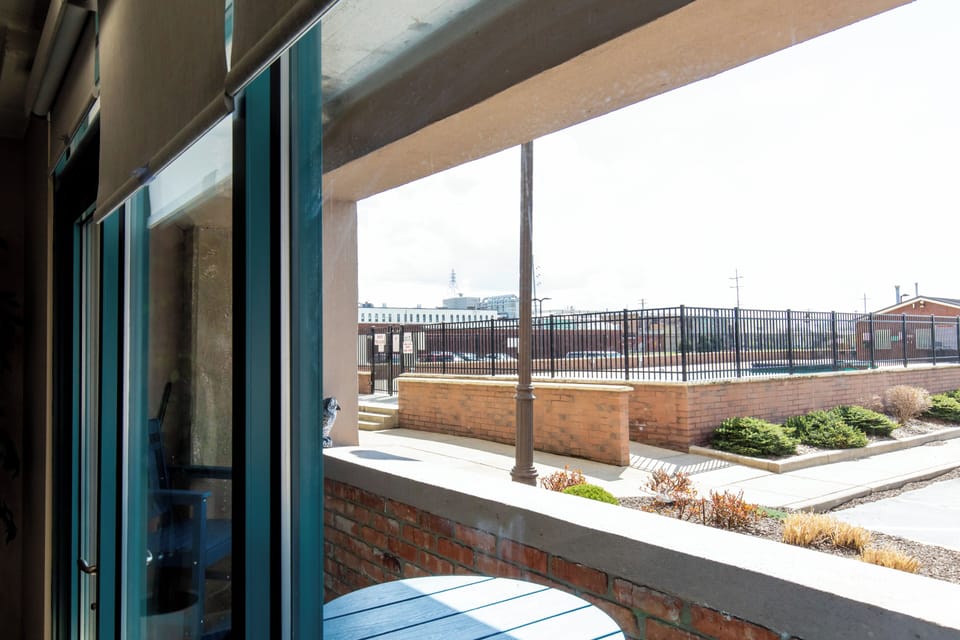 Step onto your private balcony to enjoy fresh air and peaceful courtyard views from your comfortable outdoor space.