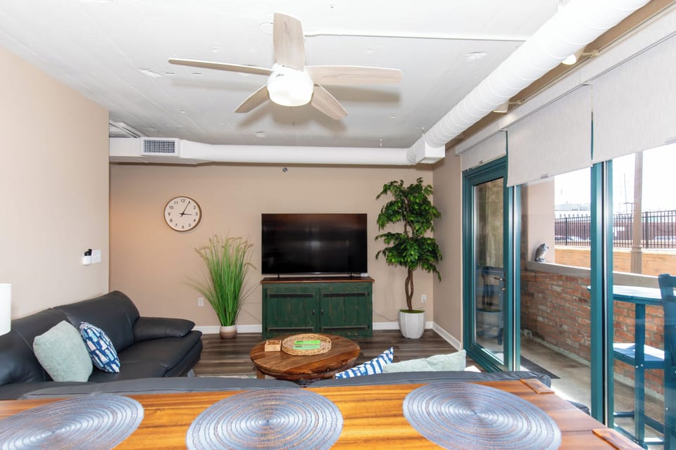 Relax in your stylish living room with modern furnishings, exposed beams, and your own private balcony overlooking the city.