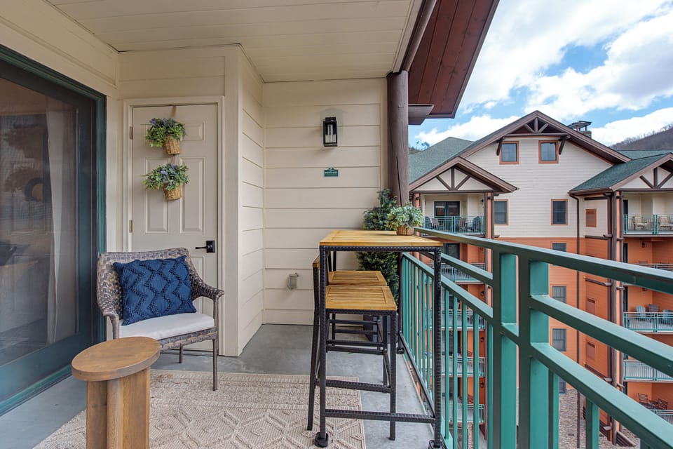 Step onto your private balcony for morning coffee with mountain views. Cozy seating and bistro table create the perfect spot to unwind.