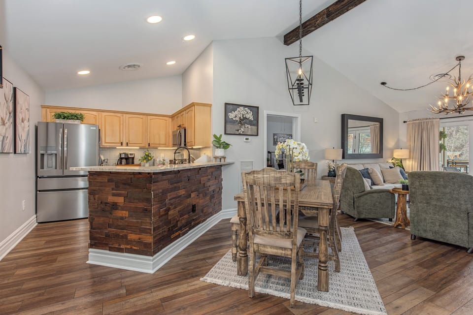 You'll love gathering in this open-concept space where rustic stone and warm wood blend beautifully with modern comfort.