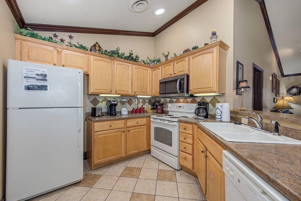 Your fully equipped kitchen features modern appliances and warm wood cabinetry, perfect for preparing meals during your stay.