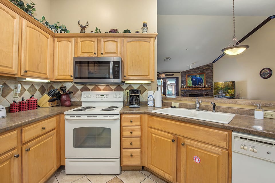 Your fully equipped kitchen awaits with warm wood cabinets, granite countertops, and all the appliances you need to create memorable meals during your stay.
