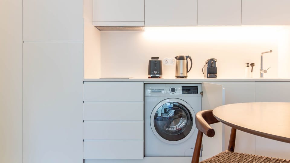 Sleek kitchen with built-in washer. #ConvenientLiving #ModernAmenities