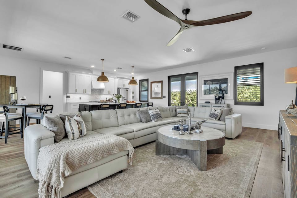 Spacious living area flowing into a modern chef’s kitchen—perfect for entertaining and group gatherings.