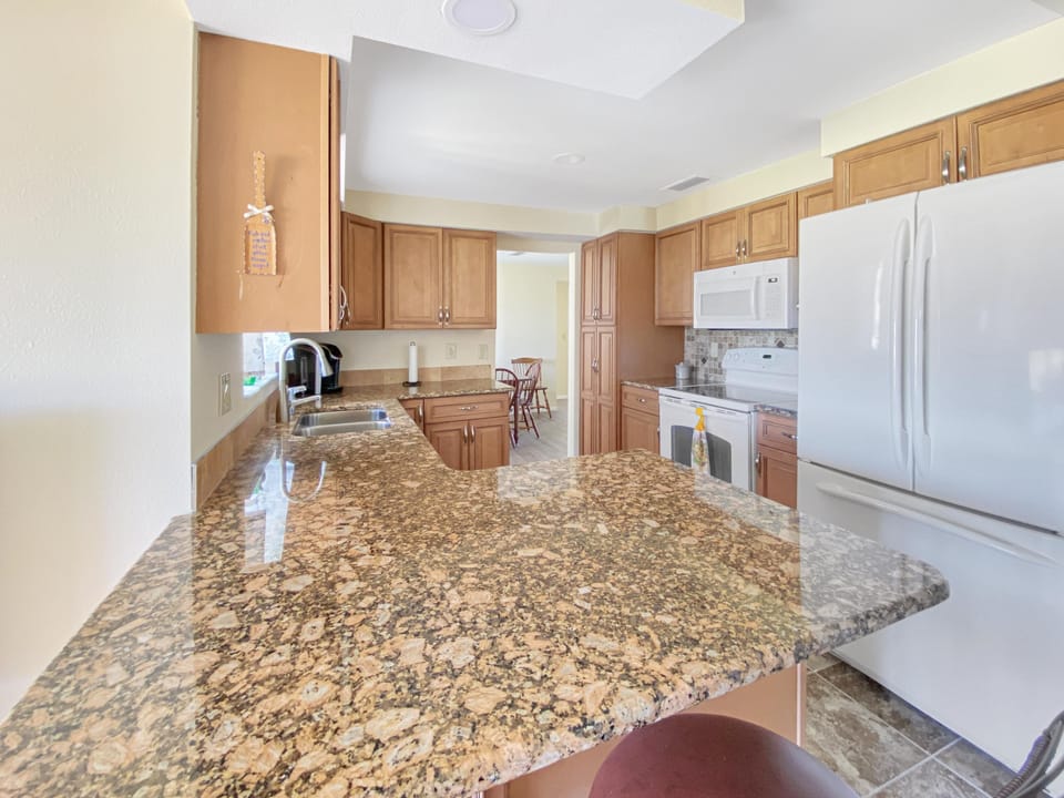 Spacious kitchen with granite countertops and modern appliances, perfect for family meals.