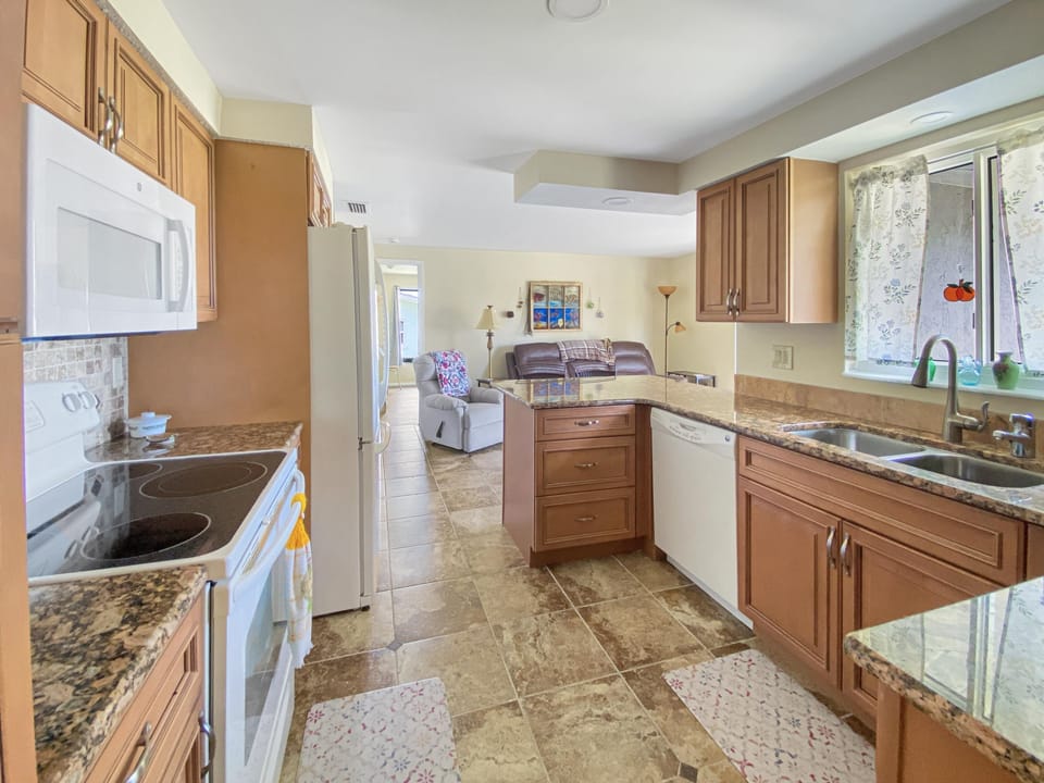 Modern kitchen with granite countertops and ample natural light, perfect for cooking and entertaining.