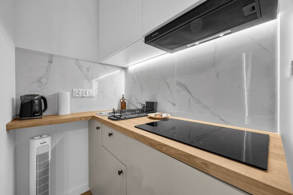 Sleek Kitchenette with Induction Cooktop & Modern Finishes | Book Now with RENTUJEMY.COM