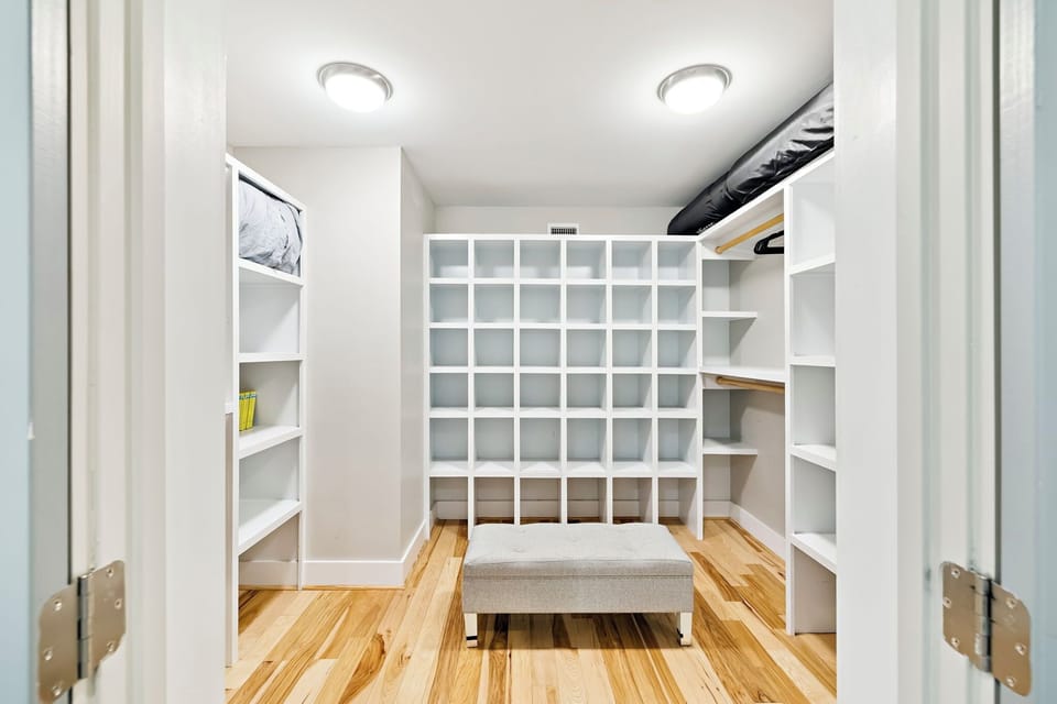 Your dream closet awaits with custom shelving for shoes, clothes, and accessories, plus a cozy bench for getting ready.