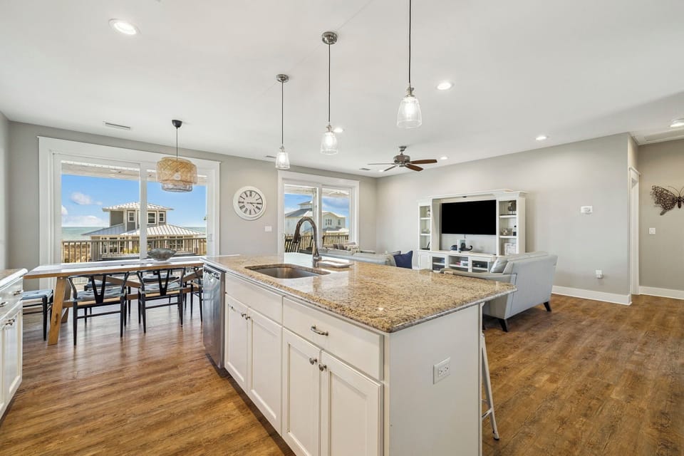 Your open-plan kitchen flows seamlessly into the living space, featuring granite countertops and modern appliances perfect for preparing memorable meals.