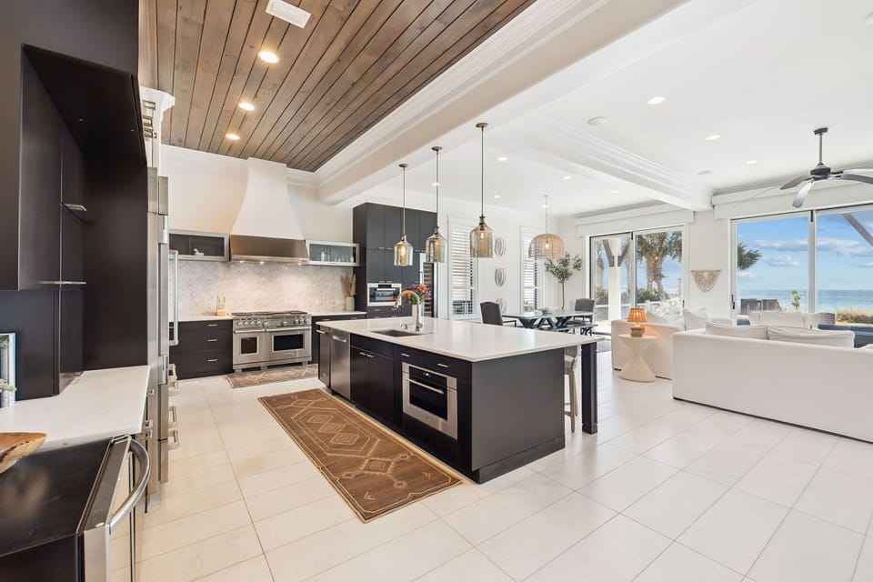 Your gourmet kitchen awaits with sleek granite countertops, premium appliances, and ocean views through expansive windows.