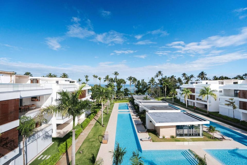 Unwind in our shared spaces—take a dip in the pool, relax under the palms, and soak up the laid-back beachfront vibe just steps from the shore.