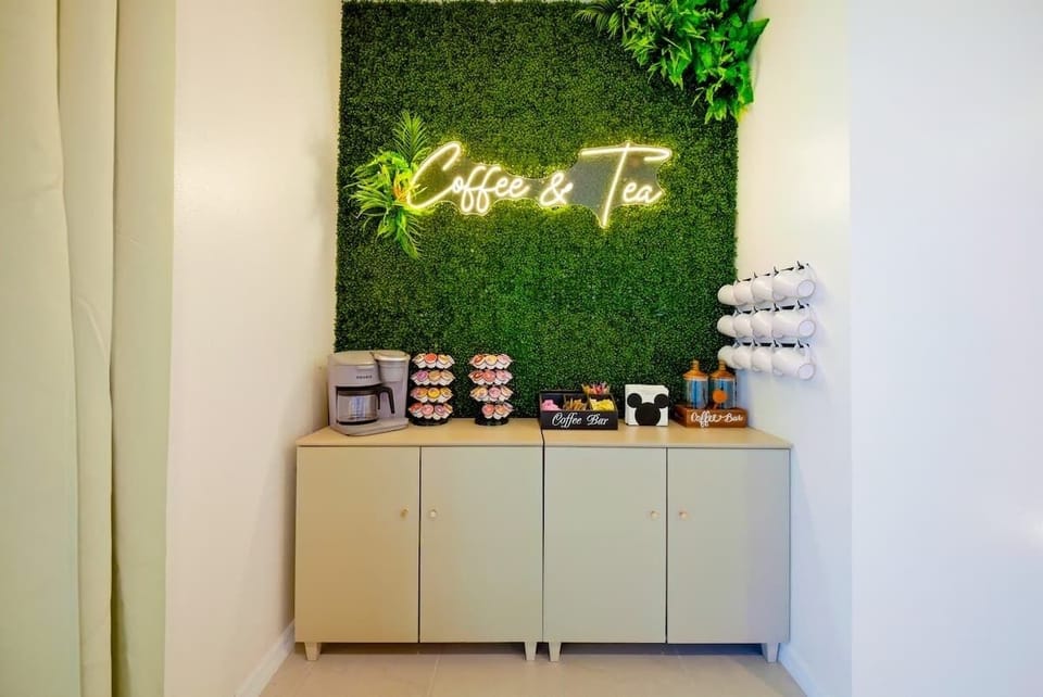 Fully stocked coffee bar with Keurig, electric tea kettle, assorted K-Cups, creamer, and sweeteners.