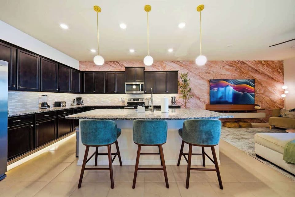 Open concept kitchen featuring stainless steel appliances, granite countertops, all essential small appliances, cookware, dinnerware, bakeware, cutlery, and glassware. Kid-friendly cups and dinnerware are also provided. 