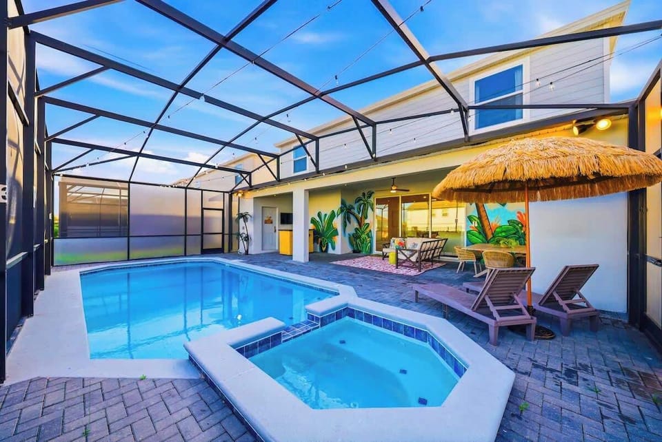 Private pool and hot tub with sun loungers, outdoor dining and lounge space, tiki bar, and smart TV. 