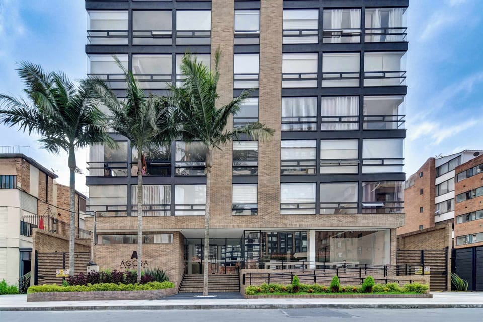 Modern building exterior located in a central Bogotá neighborhood.