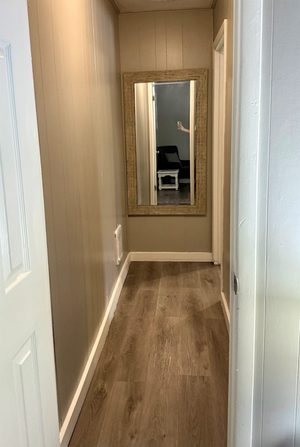 Hall leading back to daybed room with mirror.