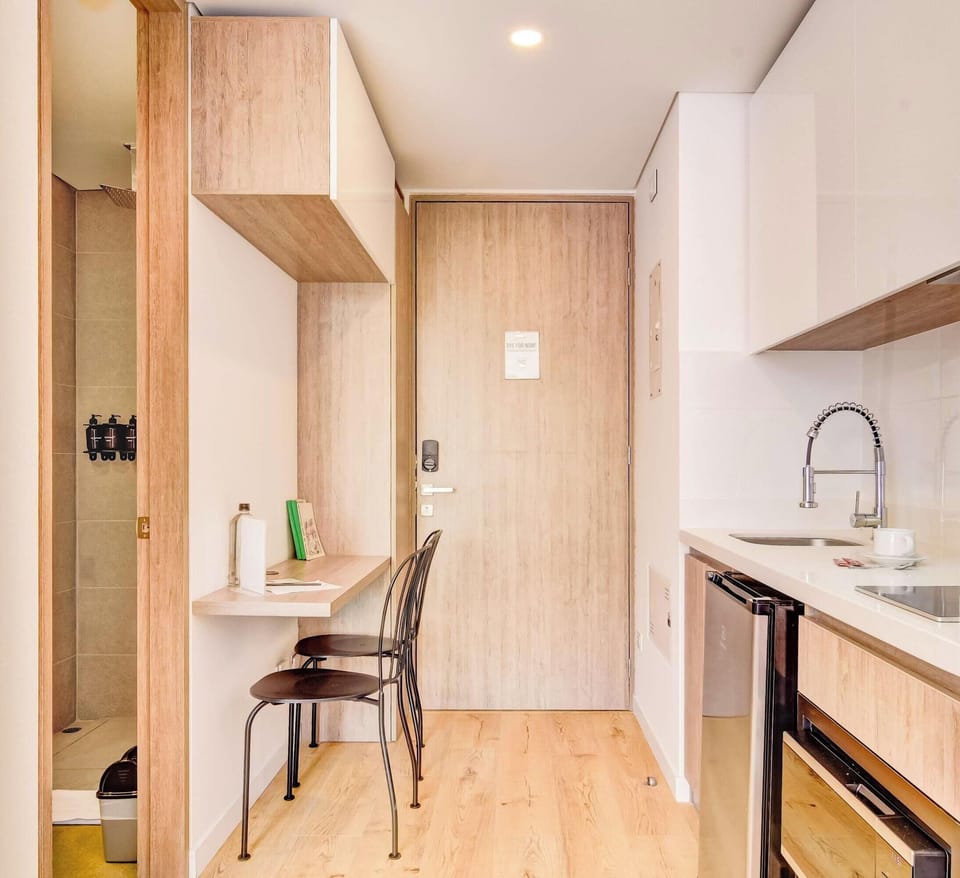 View of the kitchen with a small table for working or dining.