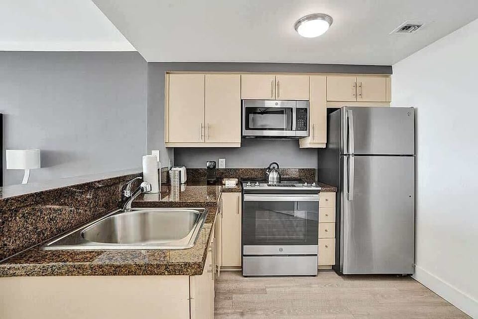 Kitchen with sink, stove and refrigerator