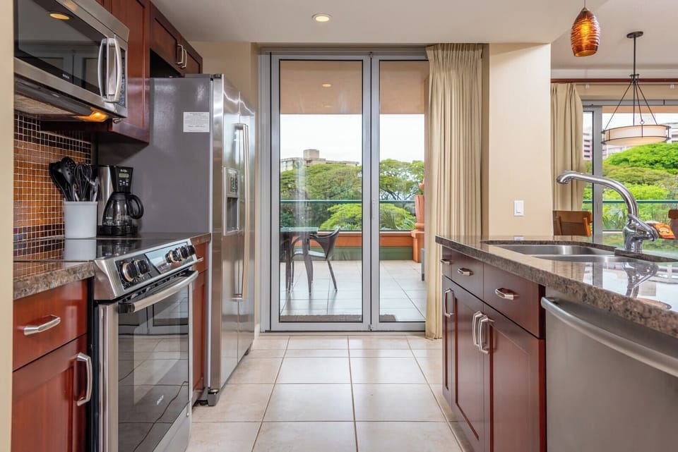 Modern kitchen with stainless appliances and direct access to lanai HKK-234
