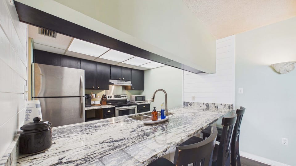 Breakfast bar attached to kitchen with high chairs for 3