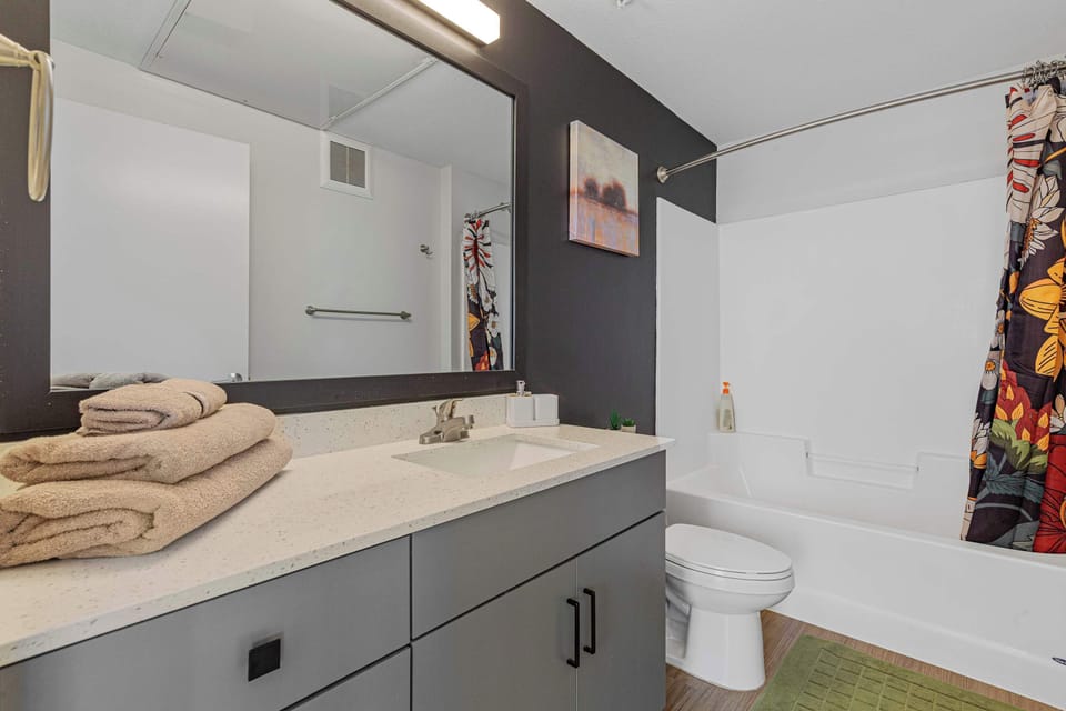 Get ready without feeling cramped in this clean bathroom with generous counter space and fresh towels ready for your stay.