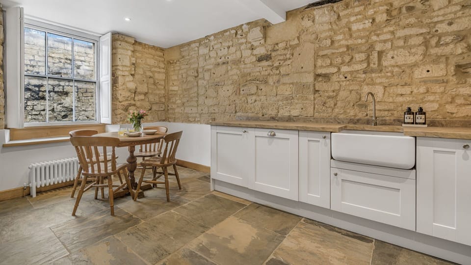 The house incorporates original, exposed Cotswold stone walling throughout.
