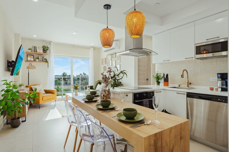 Bright open kitchen and dining space with everything needed for easy meals at home, plus lots of natural light and a cozy island for coffee or breakfast.