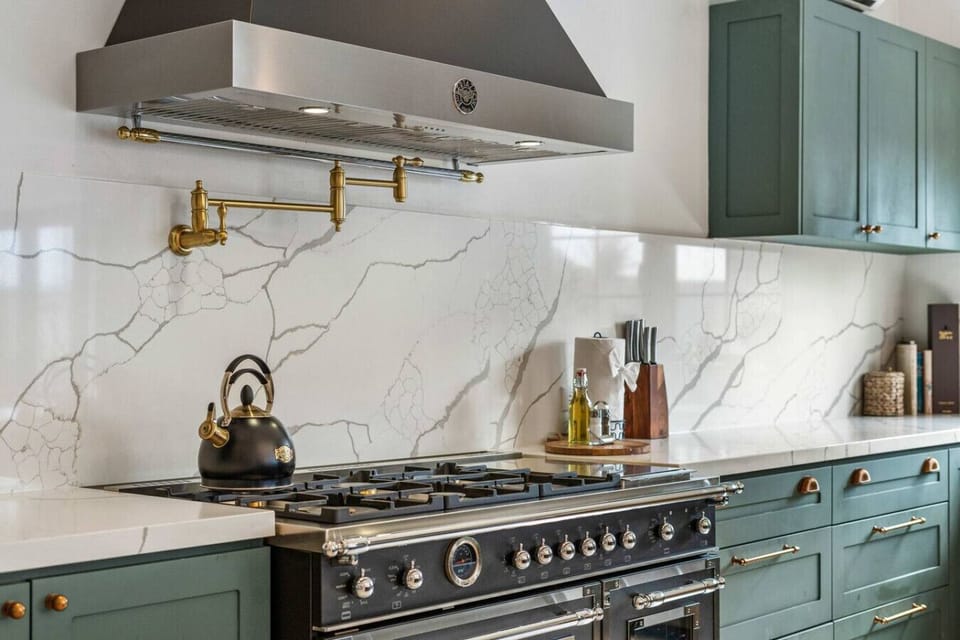 Modern kitchen with gas range and marble backsplash for easy meals