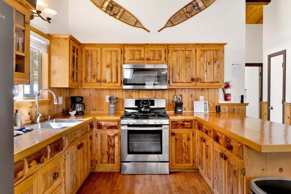 Fully equipped cabin kitchen with ample cabinetry, stove, fridge, microwave, and coffee maker—perfect for cooking meals, morning coffee, and feeling right at home on your stay.
