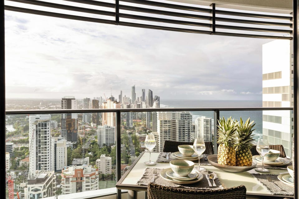 Covered balcony dining with skyline and coastal views. Perfect for breakfast in the sun, sunset drinks or an easy dinner with the city lights on
