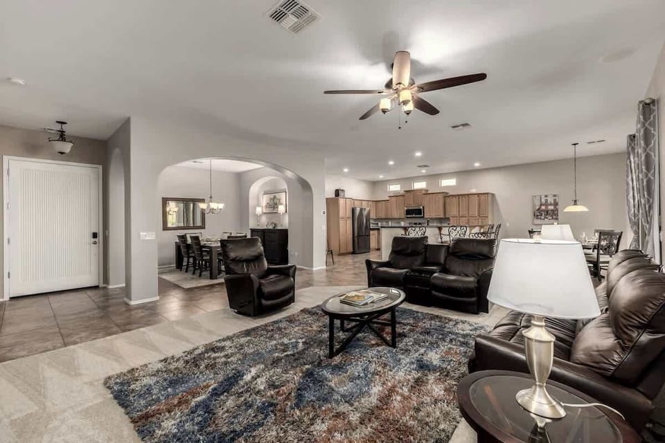 Spacious living room with plush reclining seating, perfect for movie nights and group gatherings.