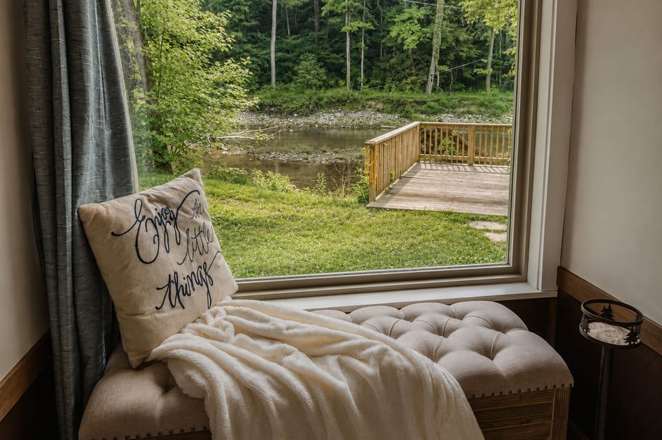 Cozy window seat with peaceful creek views and private outdoor deck