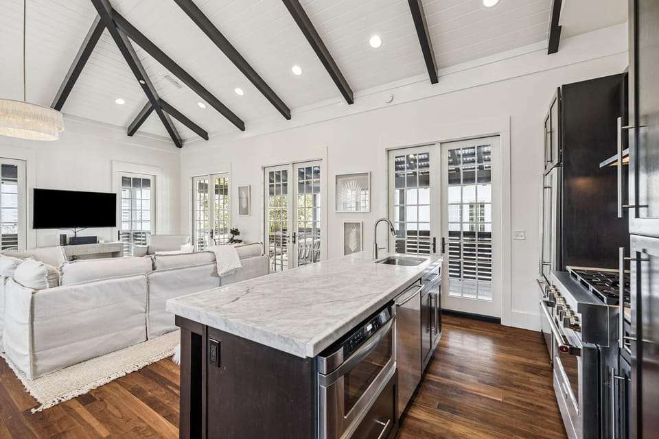 Sunlit kitchen and living area with vaulted ceilings and cozy charm