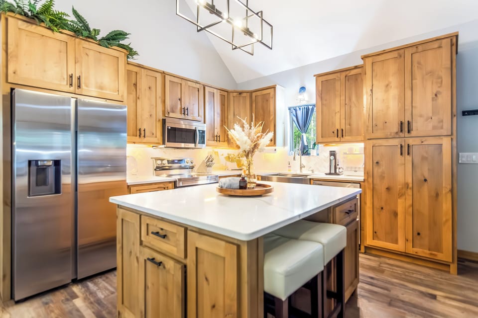 Modern, open concept kitchen with stool seating & all modern appliances