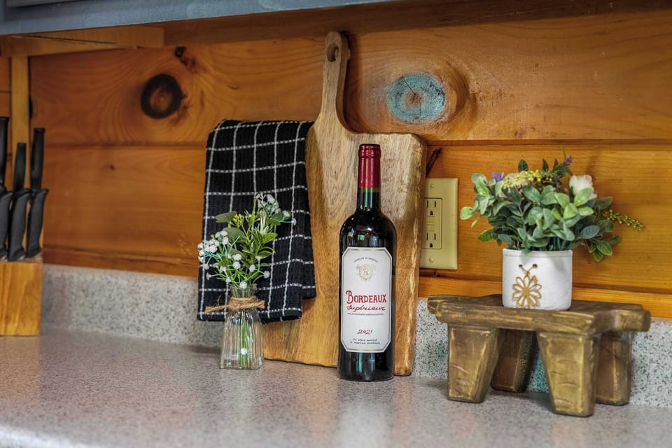 A good Bordeaux, a wooden board, and a mountain cabin kitchen — some evenings don't need a plan.