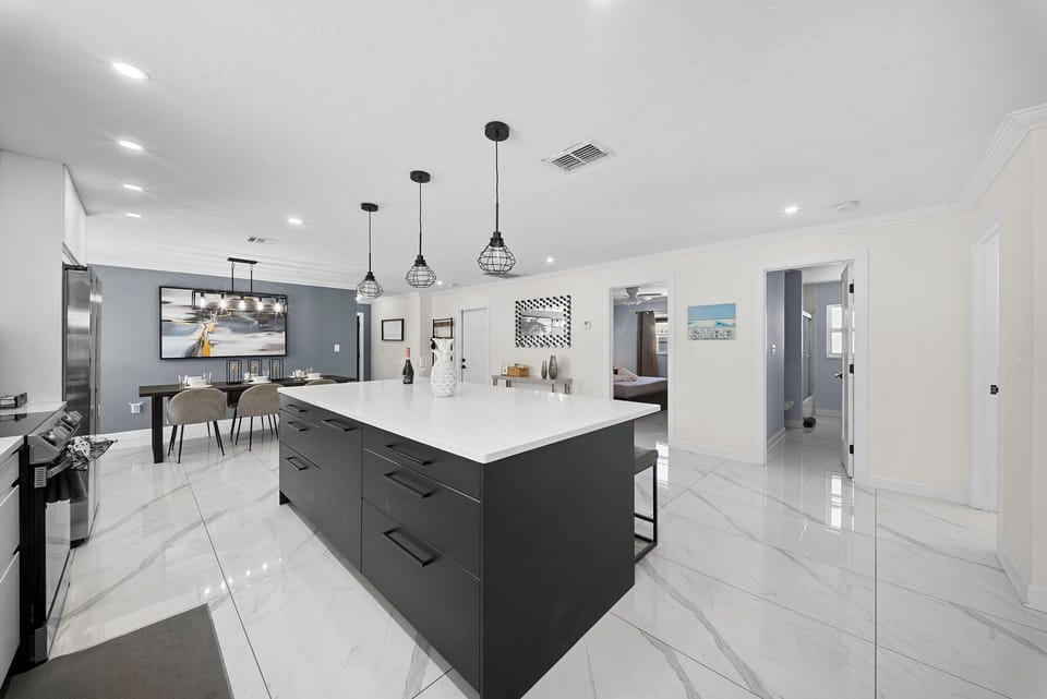 Large kitchen island with bar seating flowing into the dining area.