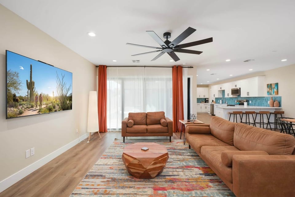 Seamless layout connects the media lounge to the kitchen with easy sliding door patio access. 