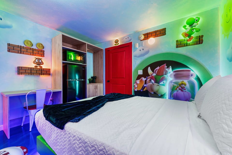 Enjoy a themed room featuring colorful Super Mario wall art and modern amenities including a mini fridge and microwave.