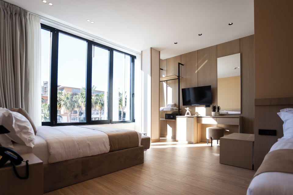 Deluxe Triple Room, City View | In-room safe, desk, laptop workspace, free WiFi