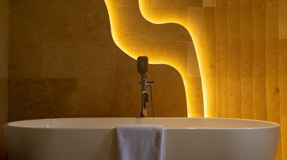 Separate tub and shower, hair dryer, slippers, towels