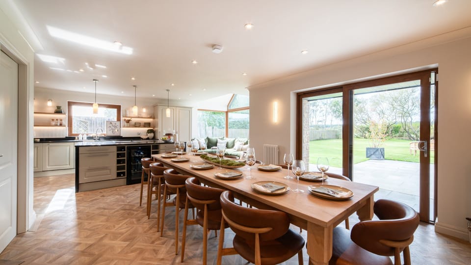 Open-plan dining flows into the kitchen and garden beyond