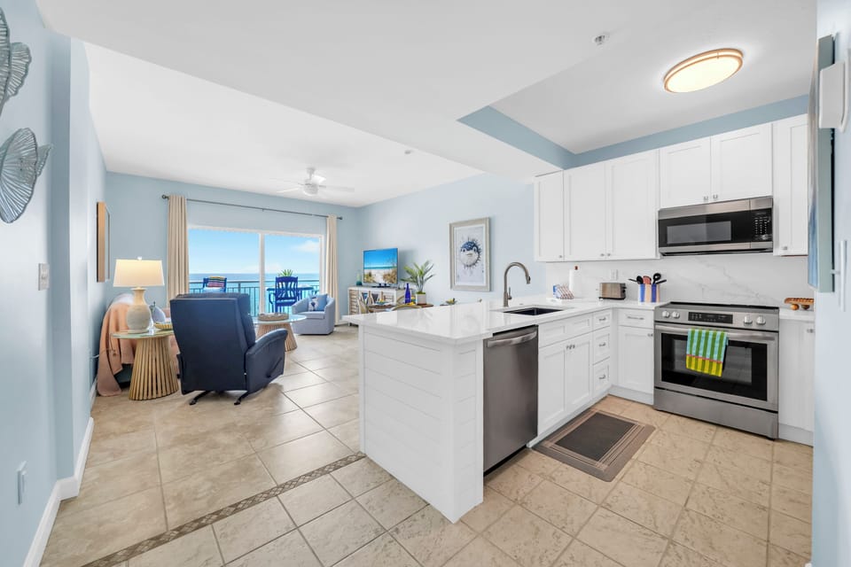 Your bright, modern kitchen flows seamlessly into the living space, where ocean views greet you from every angle.
