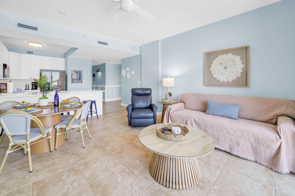 Relax in your airy open-plan space where coastal blues meet warm neutrals, creating the perfect backdrop for memorable meals and peaceful evenings.
