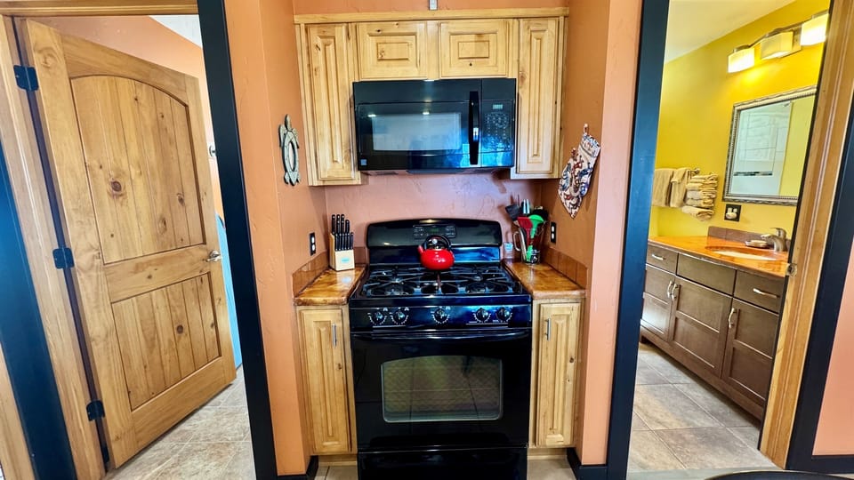 Full Bathroom to the Right & Laundry to the Left of the Gas Range
