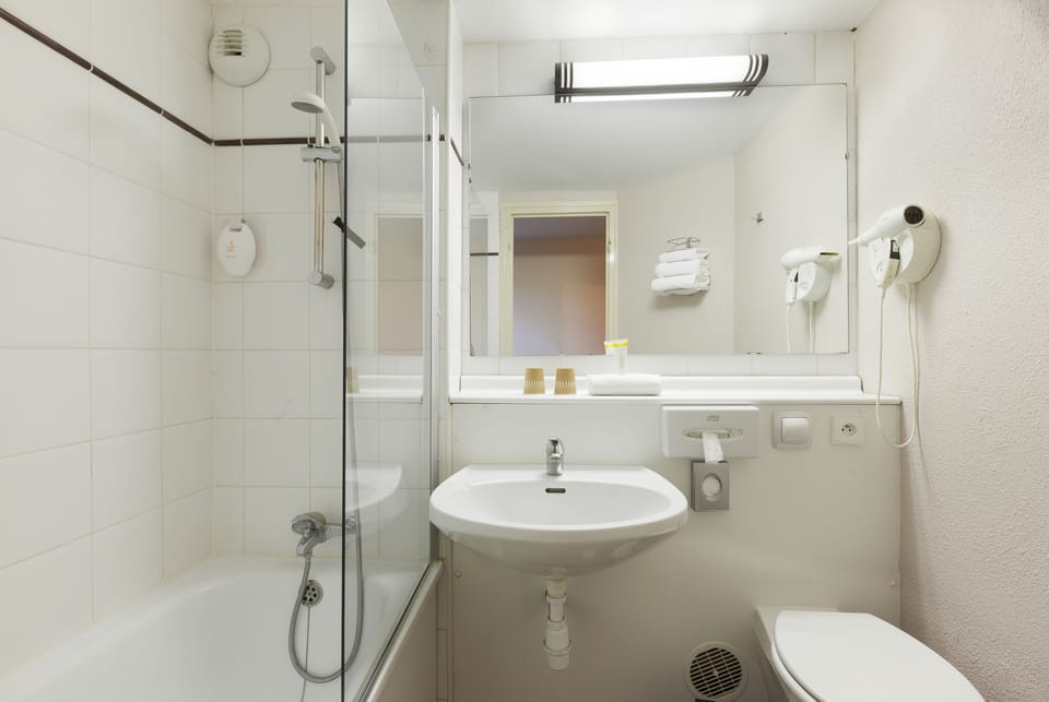 Bathtub, eco-friendly toiletries, towels