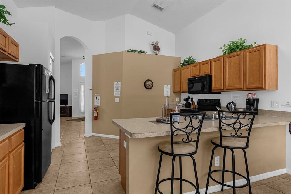 Kitchen Area With Fridge & Breakfast Bar That Seats 2 People