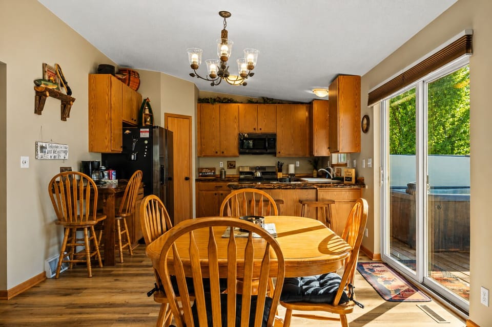 Sunny dining area with full kitchen and deck access to the hot tub