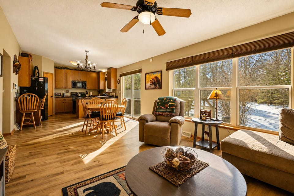 Sunny open living space with wooded views and cozy cabin charm