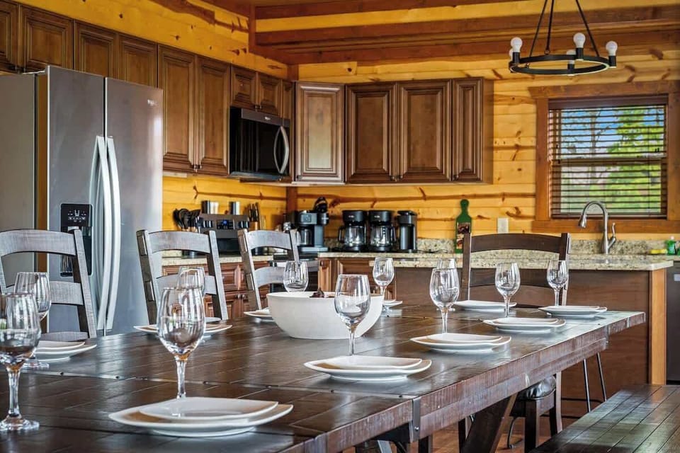 Rustic wood kitchen with large dining table, granite counters, and room to gather