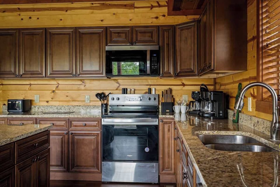 Rustic cabin kitchen with granite counters and full stainless appliances
